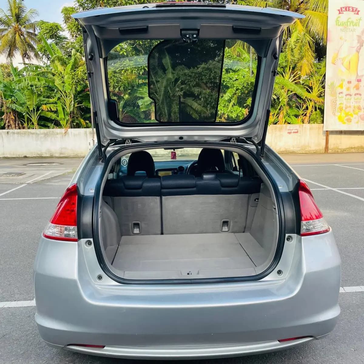Open boot of a Honda Insight self-drive rental car, empty and ready for luggage