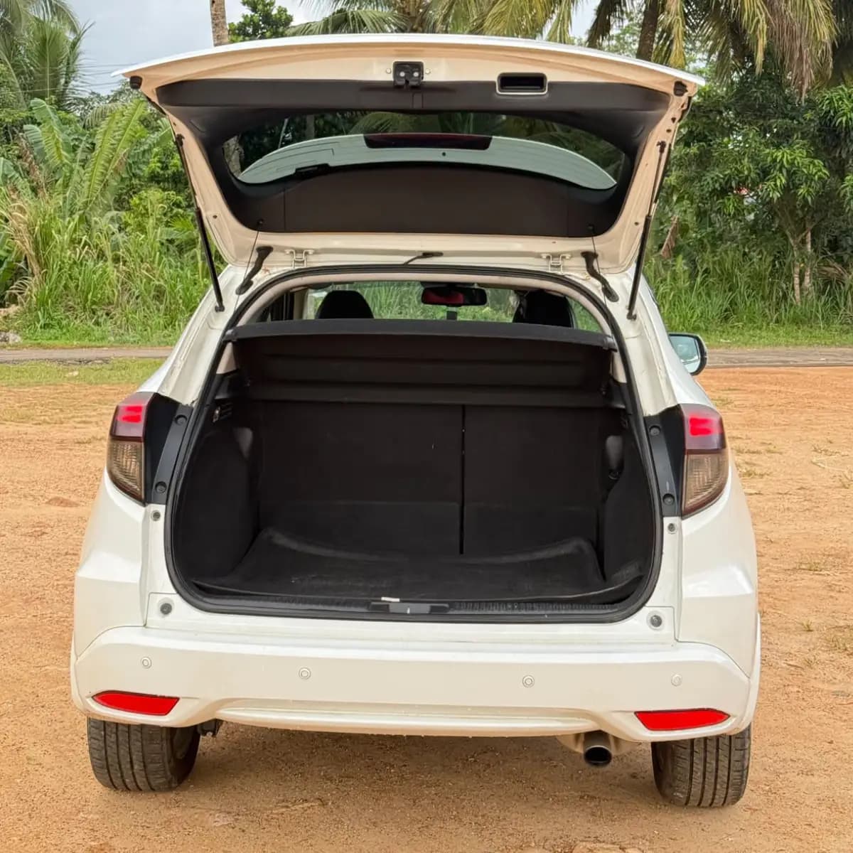 Open boot of a Honda Vezel self-drive rental car, empty and ready for luggage
