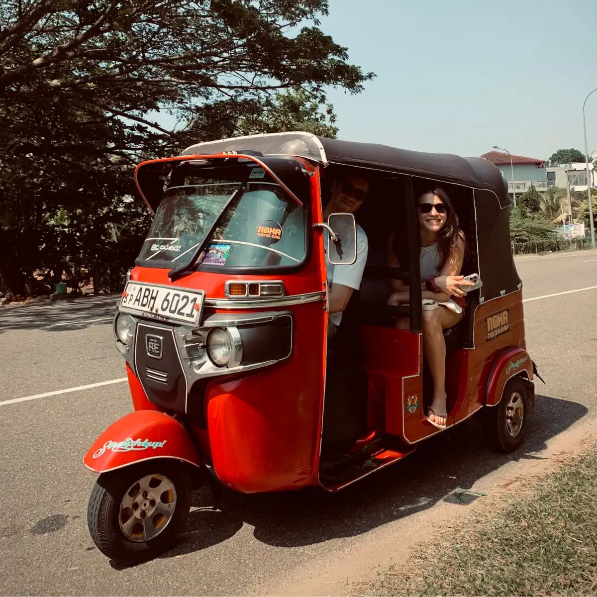 A NOHA tuk tuk on a south-coast road, an open-air alternative to a car