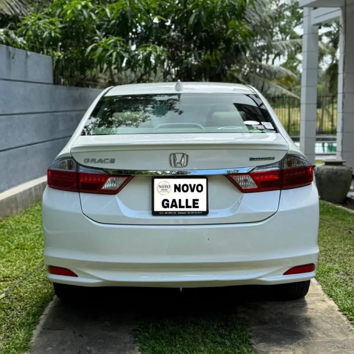 Rear view of a Honda Grace self-drive rental car from NOHA