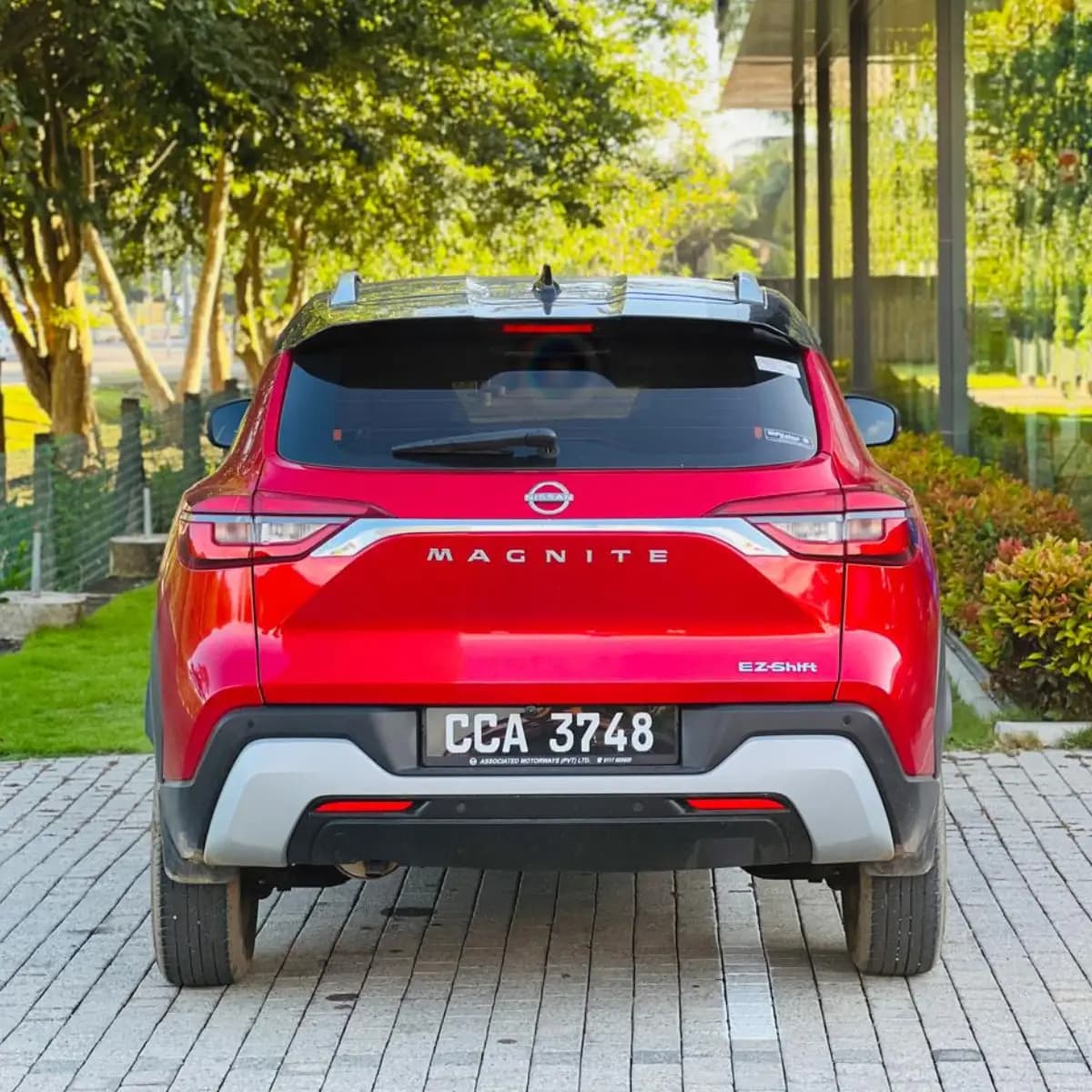 Rear view of a Nissan Magnite self-drive rental car from NOHA