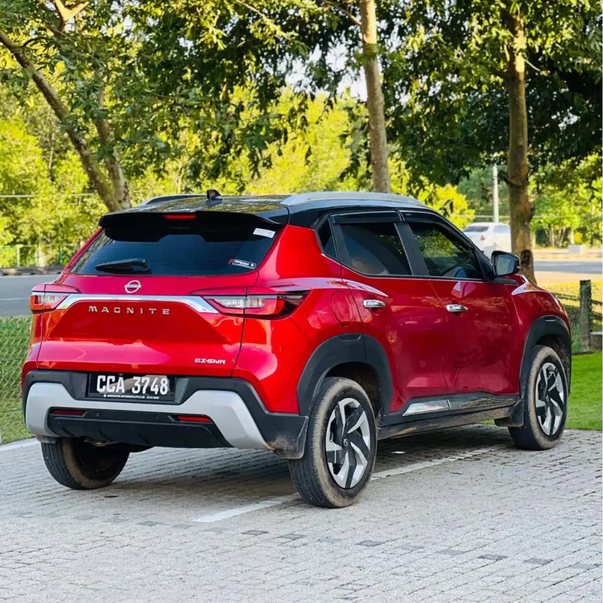Rear and side profile of a Nissan Magnite self-drive rental car from NOHA