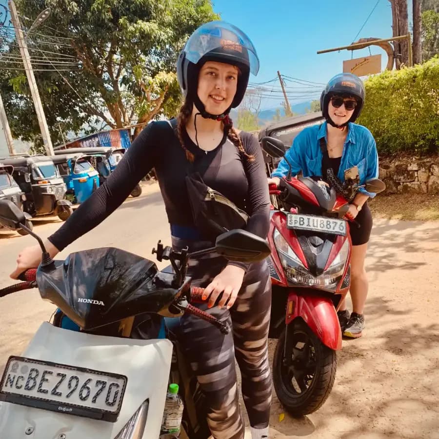 Two travellers riding NOHA rental scooters through the Sri Lankan hills
