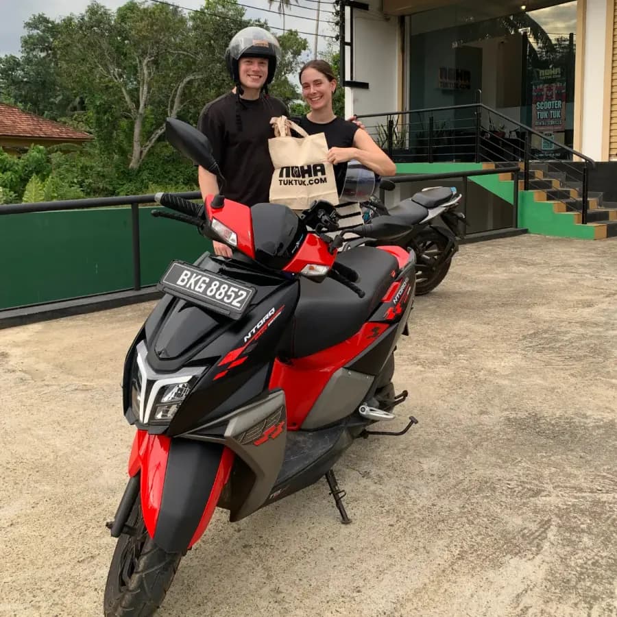 Travellers collecting their NOHA rental scooter at handover