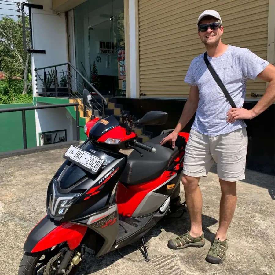 A traveller collecting their NOHA rental scooter at handover