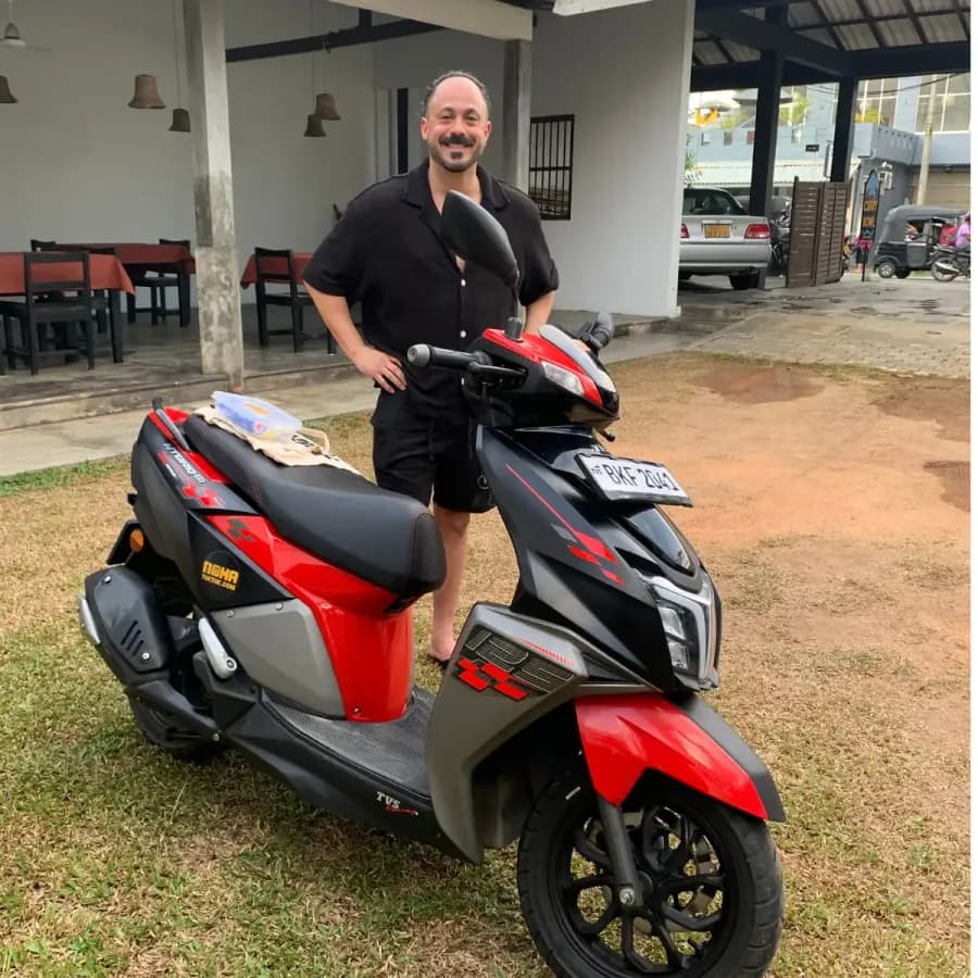 Side view of a NOHA self-drive rental scooter