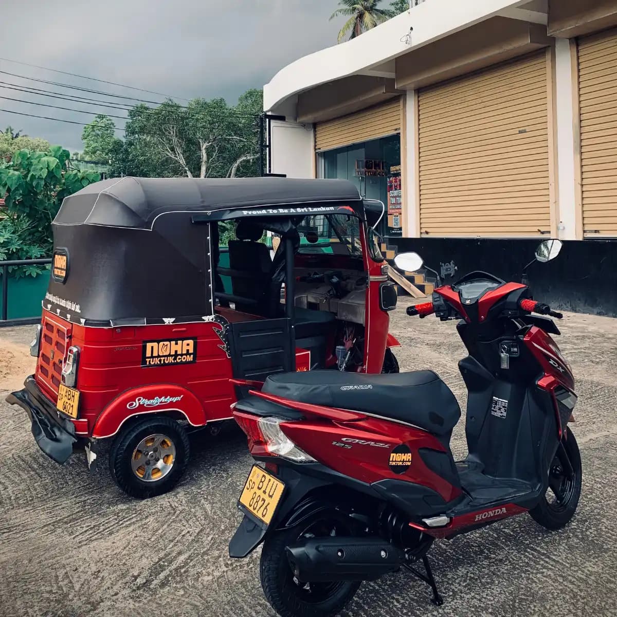 A NOHA tuk tuk parked beside a NOHA scooter