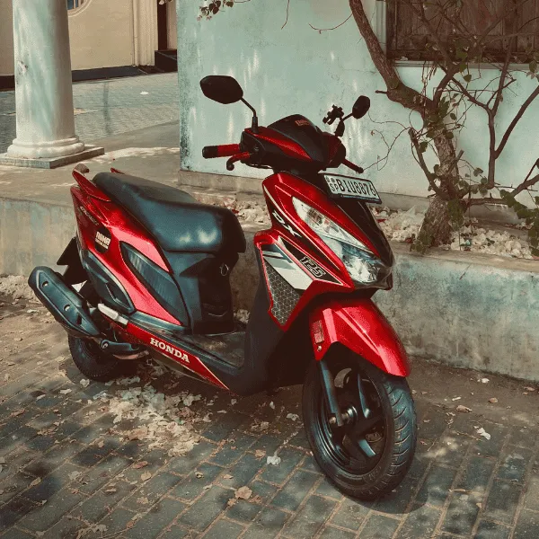 NOHA rental scooter parked on a Sri Lankan coast road